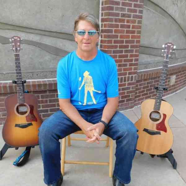 Musician performing guitar for senior community residents